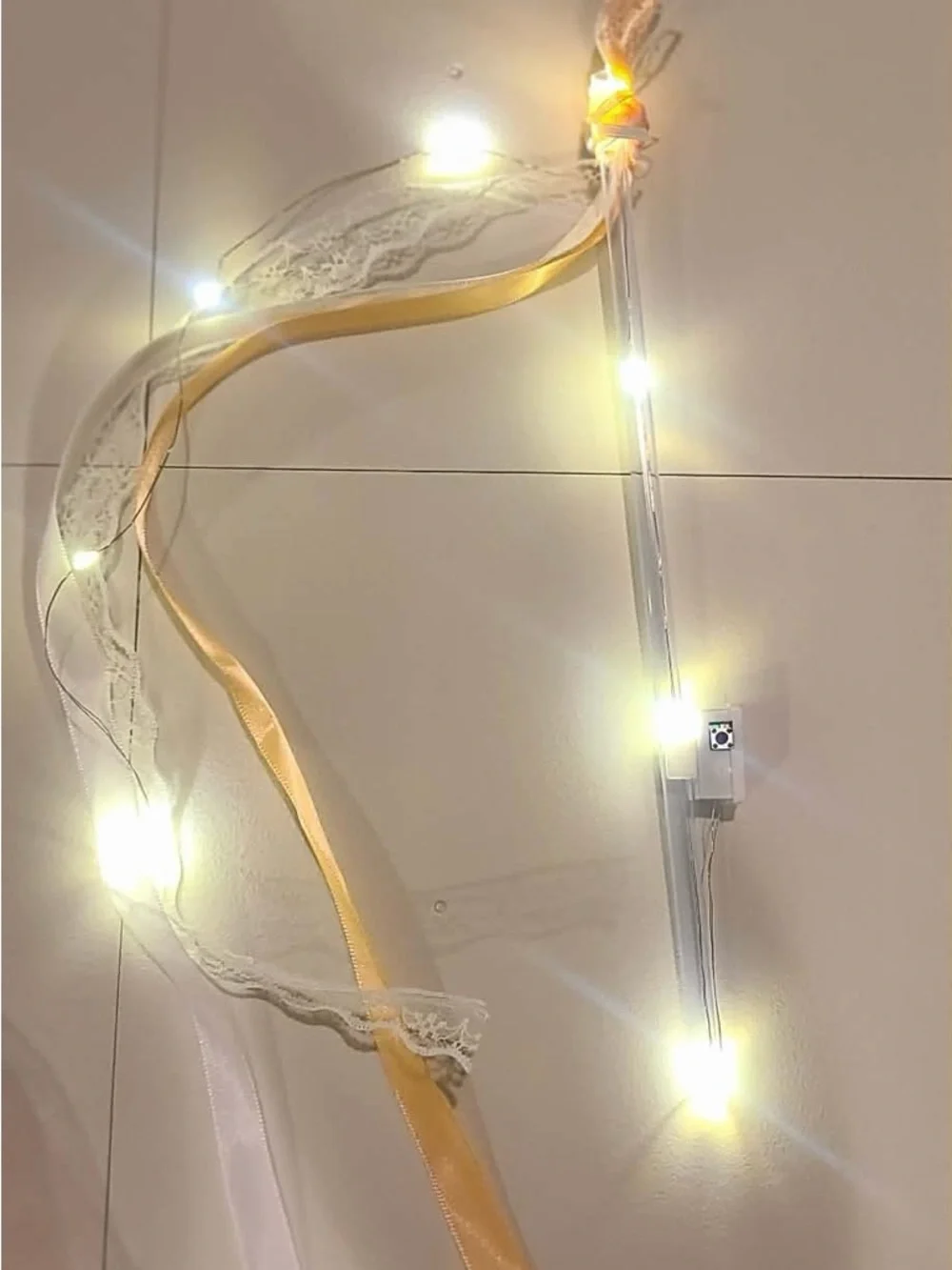 50 individually wrapped LED wands with Champagne ribbon and white lace with bell